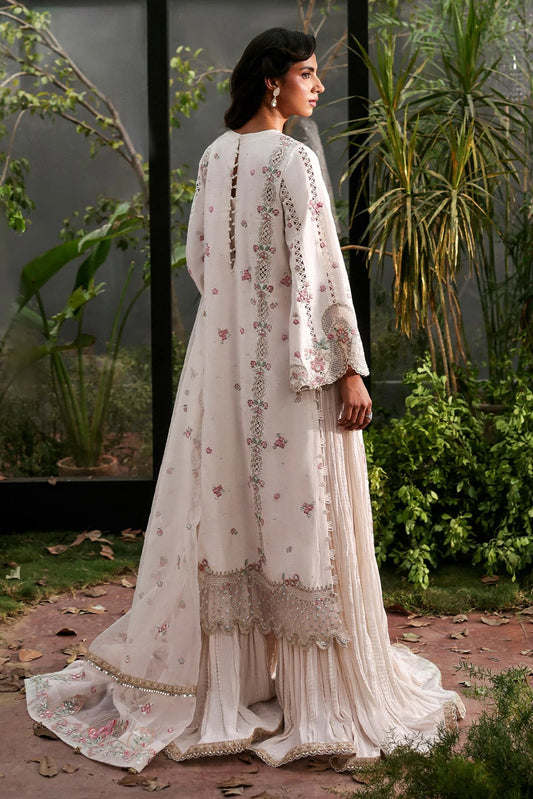Elegant white raw silk dress with intricate organza embroidery on panels, borders, and dupatta. Includes dyed trouser for a timeless, graceful ensemble.