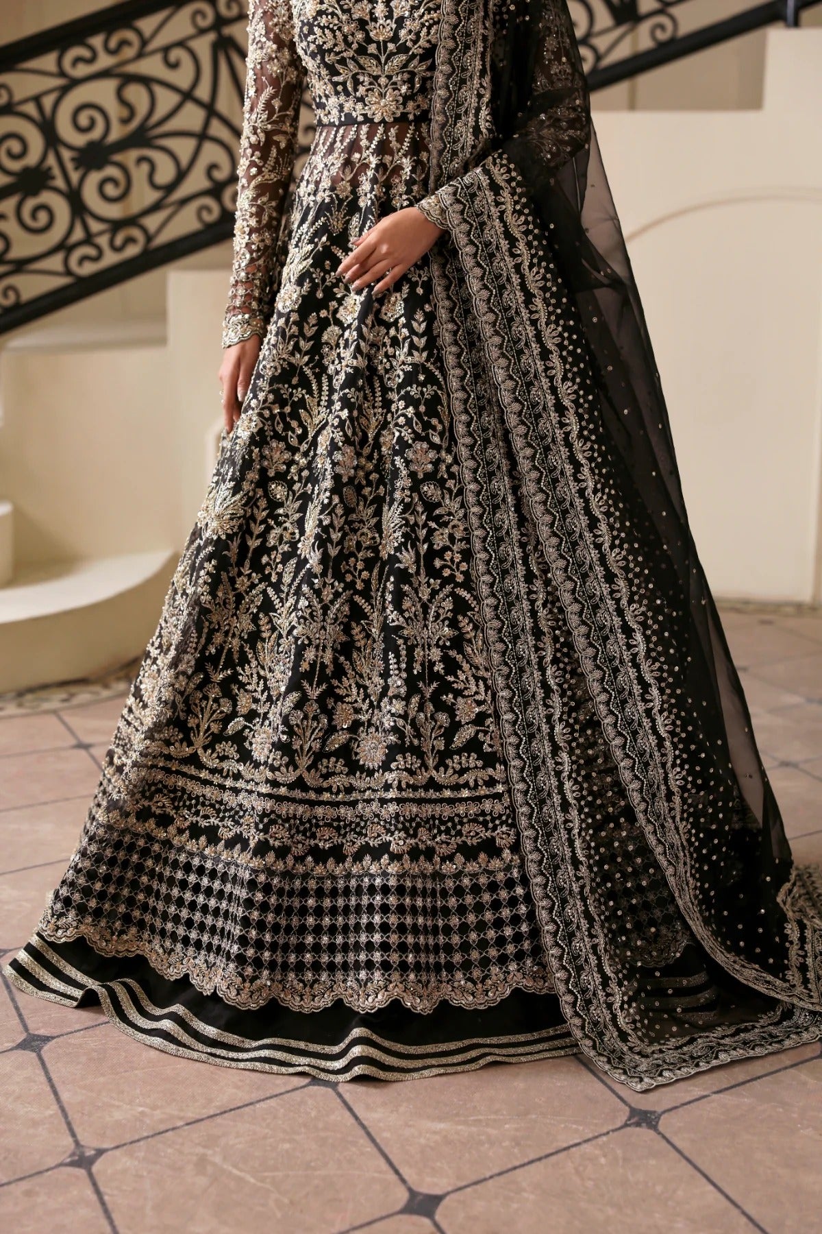 Stunning hand-embellished organza outfit with detailed panels, matching dupatta, Russian grip inner, and raw silk lehenga fabric. Ideal for formal occasions.