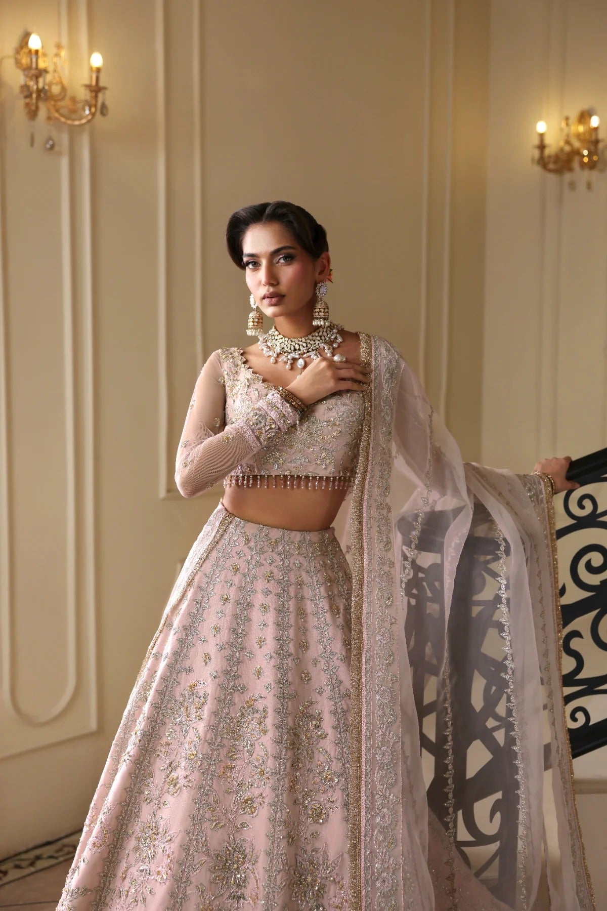 Exquisite net dress featuring hand-embellished body, sleeves, panels, and dupatta. Finished with organza kalli borders and Russian grip inner for layering.