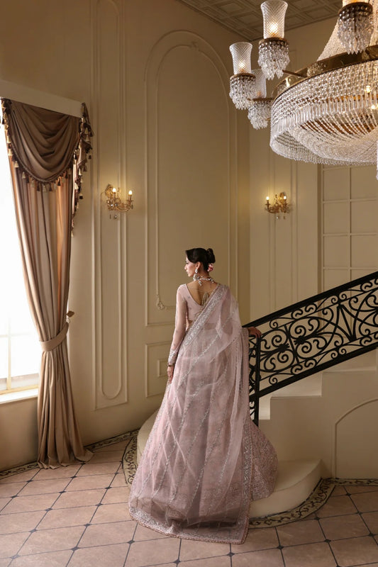 Exquisite net dress featuring hand-embellished body, sleeves, panels, and dupatta. Finished with organza kalli borders and Russian grip inner for layering.