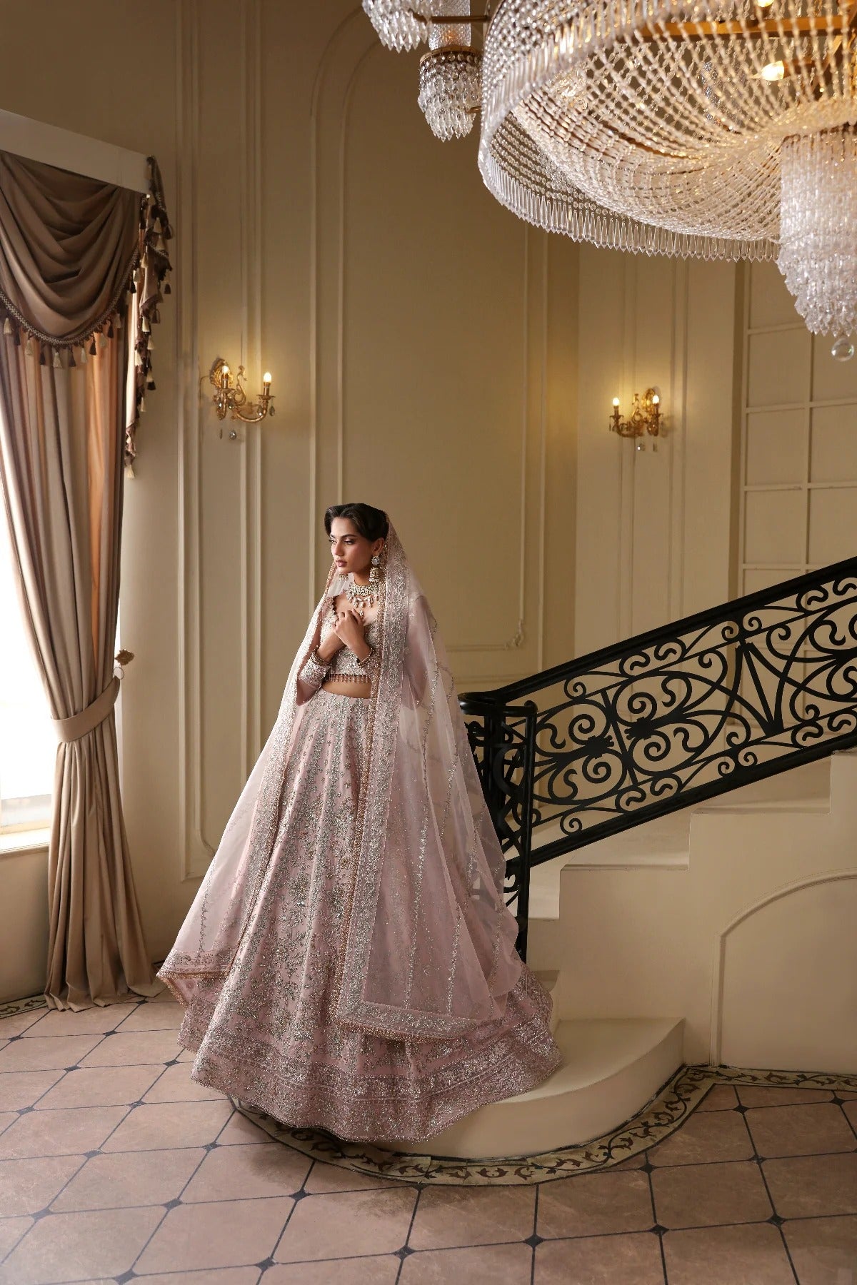 Exquisite net dress featuring hand-embellished body, sleeves, panels, and dupatta. Finished with organza kalli borders and Russian grip inner for layering.