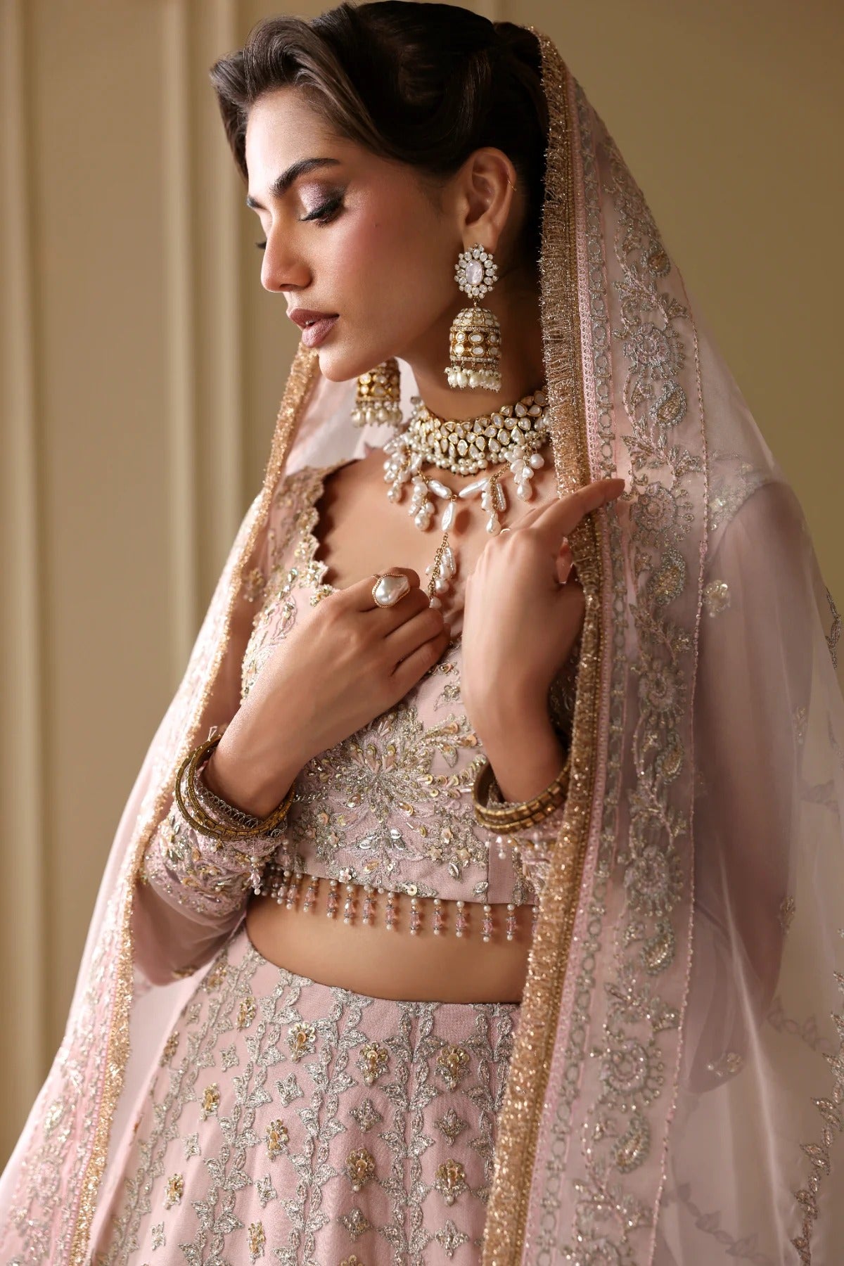 Exquisite net dress featuring hand-embellished body, sleeves, panels, and dupatta. Finished with organza kalli borders and Russian grip inner for layering.