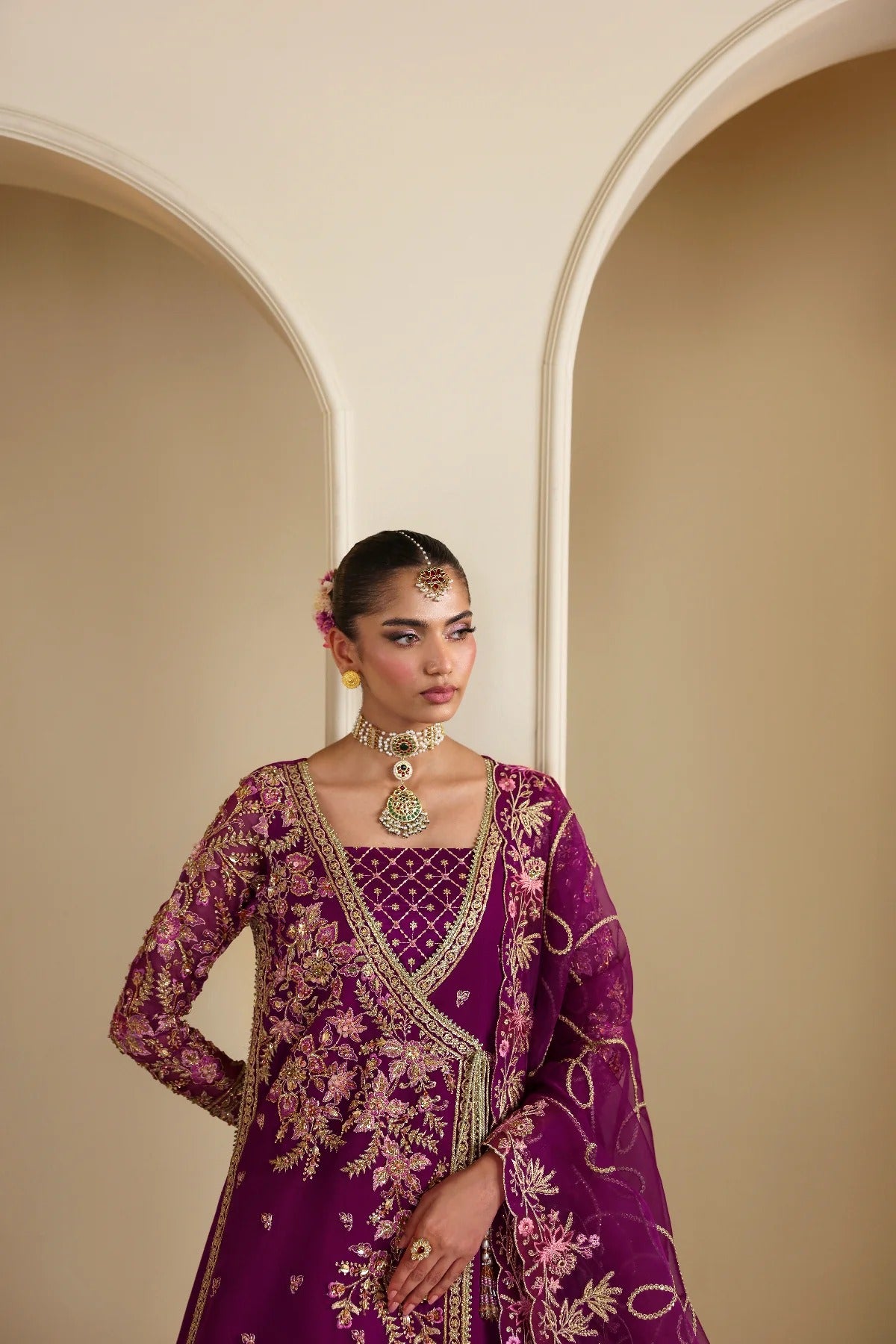 Elegant organza outfit featuring hand-embellished panels, sleeves, silk neckline, and dupatta. Includes detailed borders, Russian grip inner, and silk trouser.