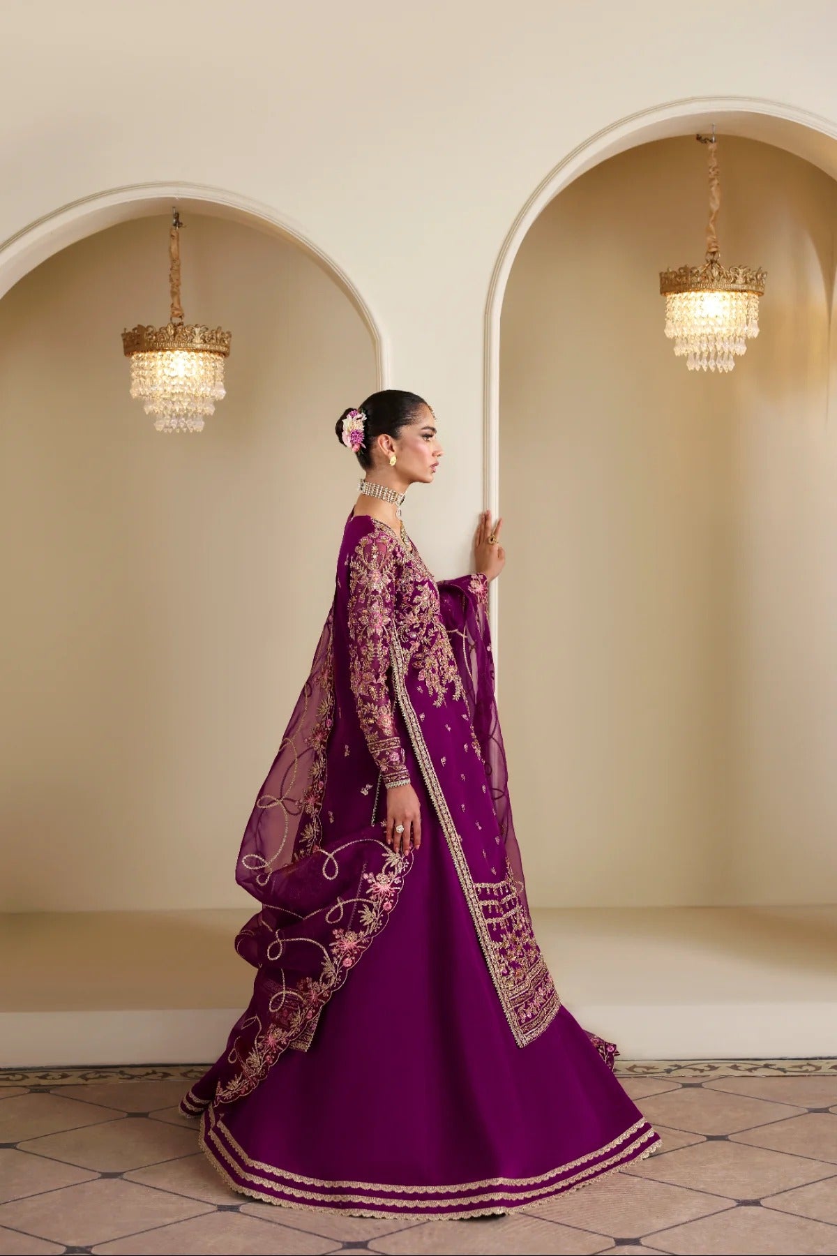 Elegant organza outfit featuring hand-embellished panels, sleeves, silk neckline, and dupatta. Includes detailed borders, Russian grip inner, and silk trouser.