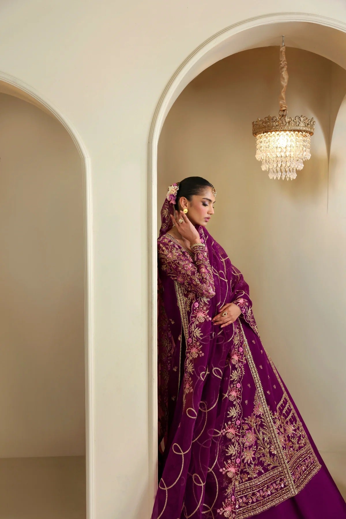 Elegant organza outfit featuring hand-embellished panels, sleeves, silk neckline, and dupatta. Includes detailed borders, Russian grip inner, and silk trouser.