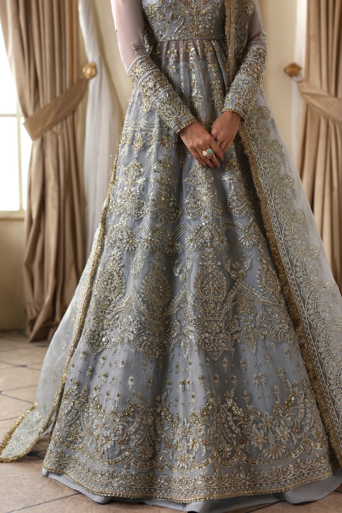 Elegant organza dress with hand embellishments, embroidered panels, matching dupatta, Russian grip inner, and 5-yard raw silk lehenga fabric. Perfect for events.