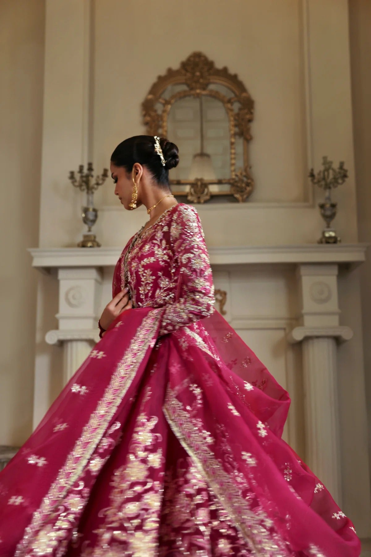 Opulent organza ensemble with hand-embellished panels, embroidered dupatta, lehenga border, Russian grip inner, and raw silk lehenga fabric. Ideal for events.