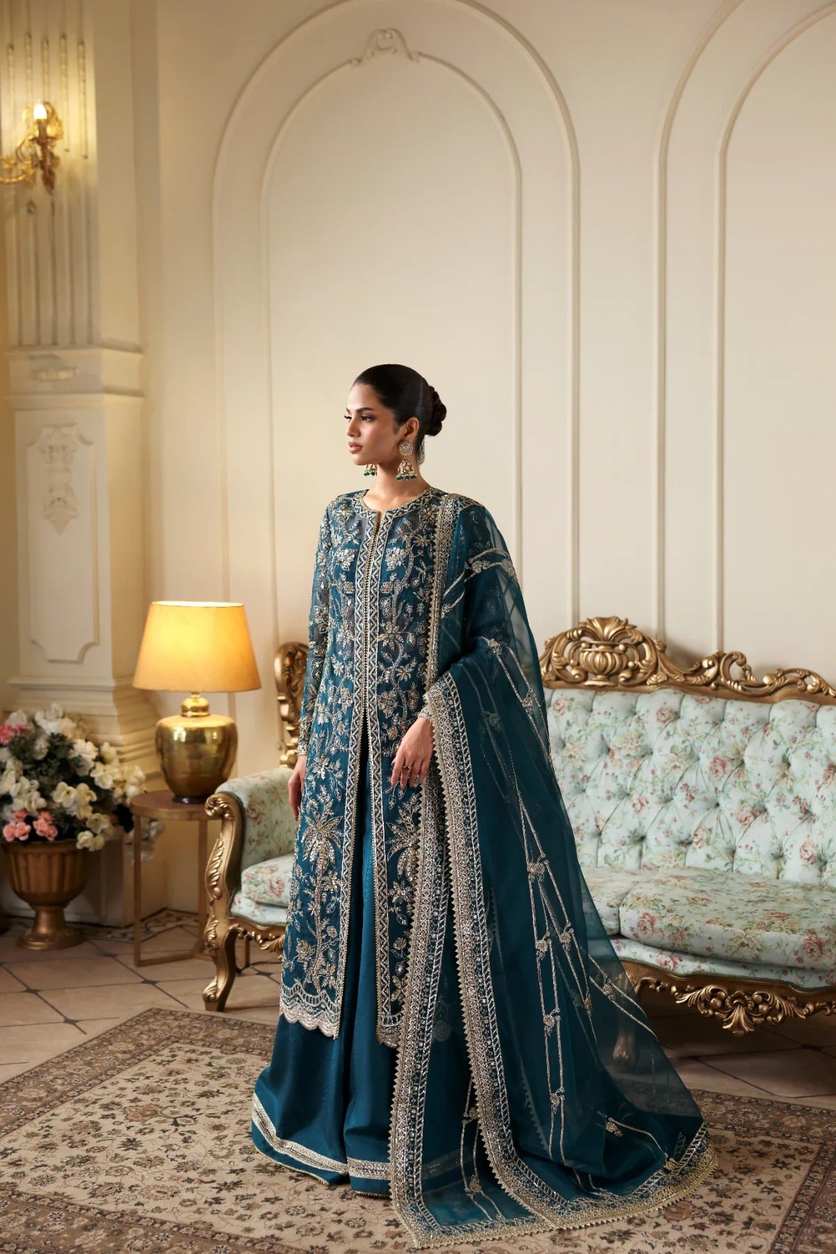 Refined organza dress with hand-embellished panels, sleeves, and borders. Includes embroidered dupatta, Russian grip inner, and raw silk trouser fabric.
