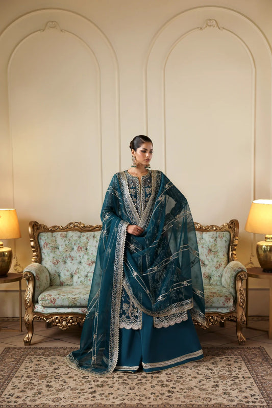 Refined organza dress with hand-embellished panels, sleeves, and borders. Includes embroidered dupatta, Russian grip inner, and raw silk trouser fabric.