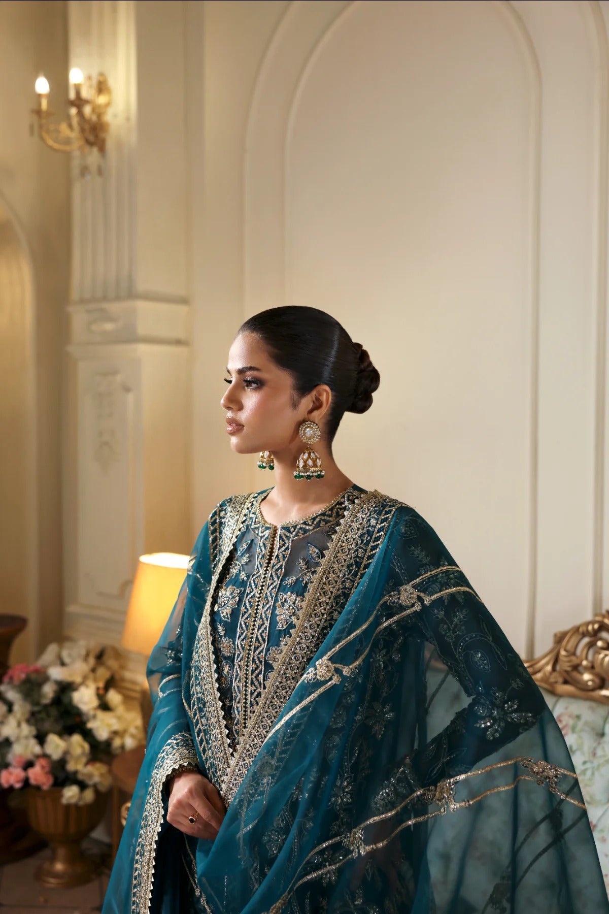 Refined organza dress with hand-embellished panels, sleeves, and borders. Includes embroidered dupatta, Russian grip inner, and raw silk trouser fabric.