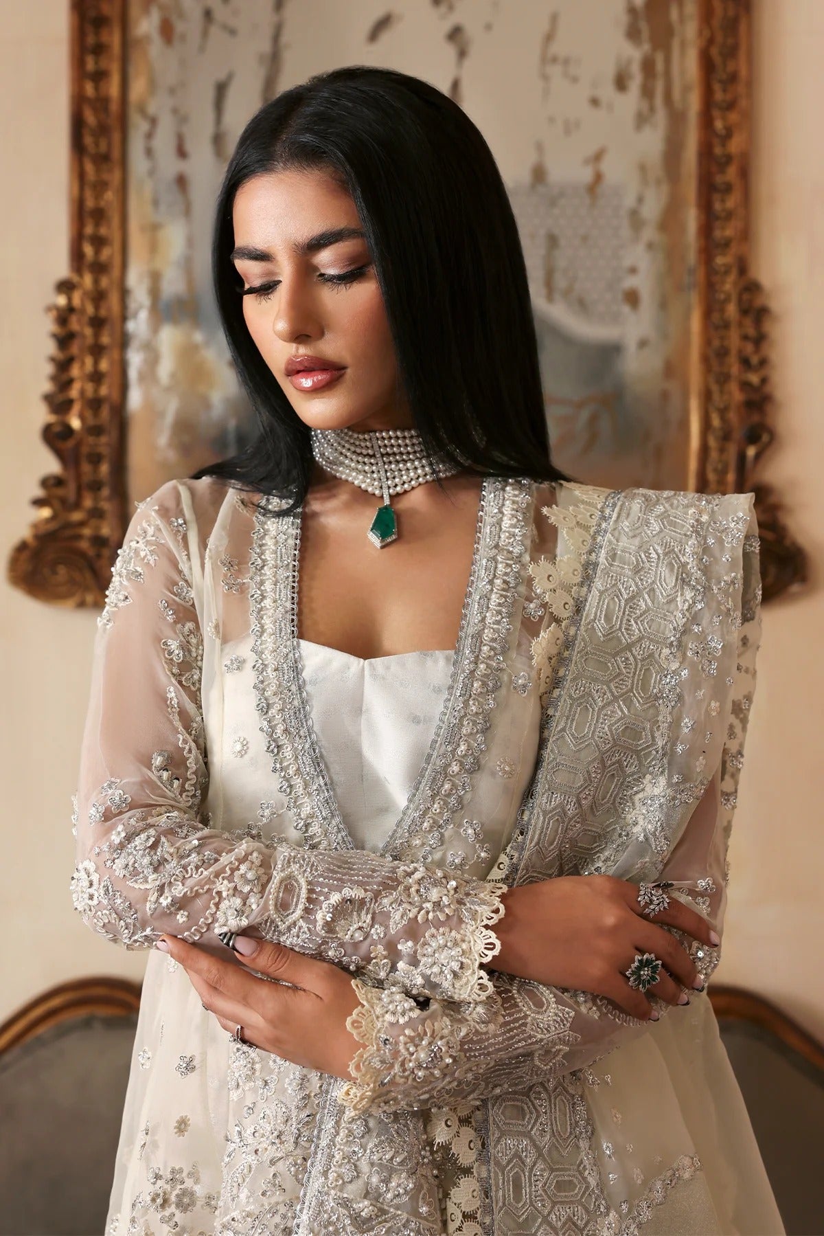 Luxurious handmade organza suit featuring embroidered front, back, and sleeves panels, paired with an elegant dupatta and zari jacquard trousers—perfect for festive occasions.