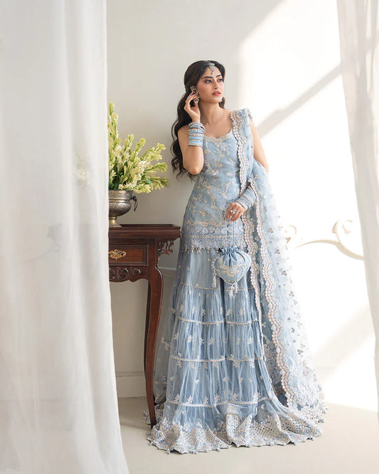 Elegant Oya gharara set in ice blue featuring intricately embroidered net shirt, gharara, and dupatta. Perfect for festive occasions and contemporary celebrations.