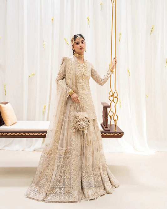 Safak ivory net gharara set with gold embroidery, featuring detailed shirt panels, embroidered dupatta, and gharara—perfect for weddings and festive celebrations.