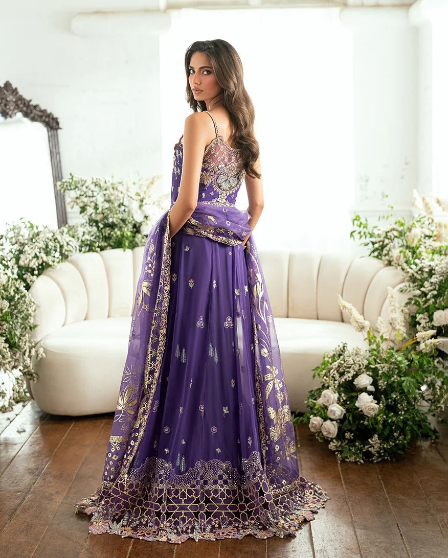 Graceful purple chiffon suit with hand embellishments, 3D daman lace, foil printed dupatta & raw silk trousers. Finished with tassels, pearls & tila lace.