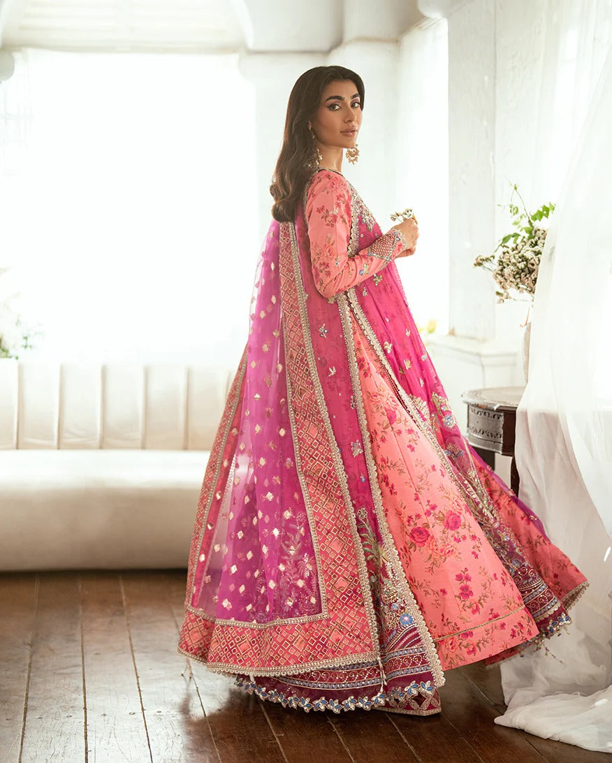 Shop this shocking pink chiffon suit with silk sleeves, lurex dupatta & raw silk trouser. Hand embellishments, sequins & tassels add a luxe festive finish!