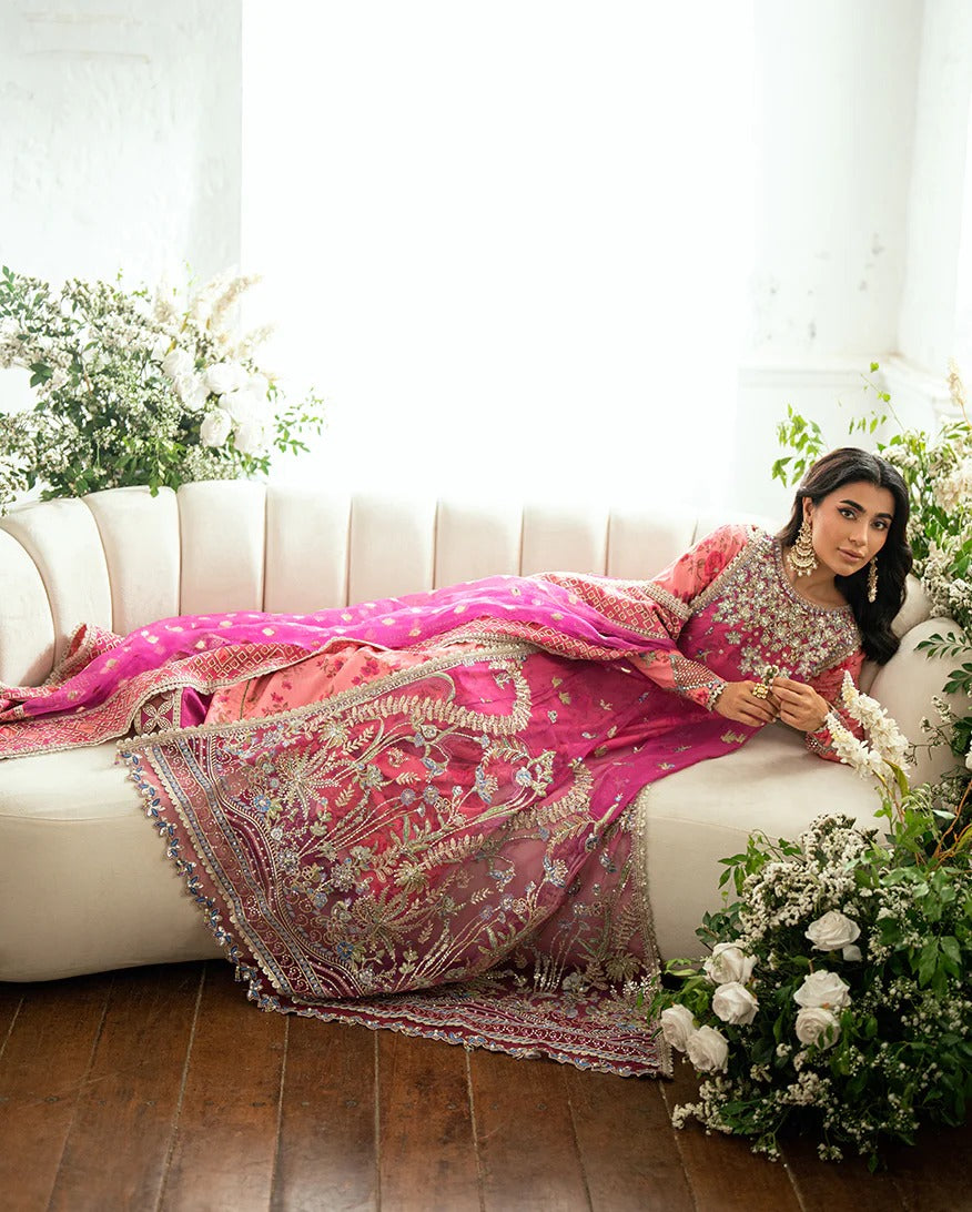 Shop this shocking pink chiffon suit with silk sleeves, lurex dupatta & raw silk trouser. Hand embellishments, sequins & tassels add a luxe festive finish!