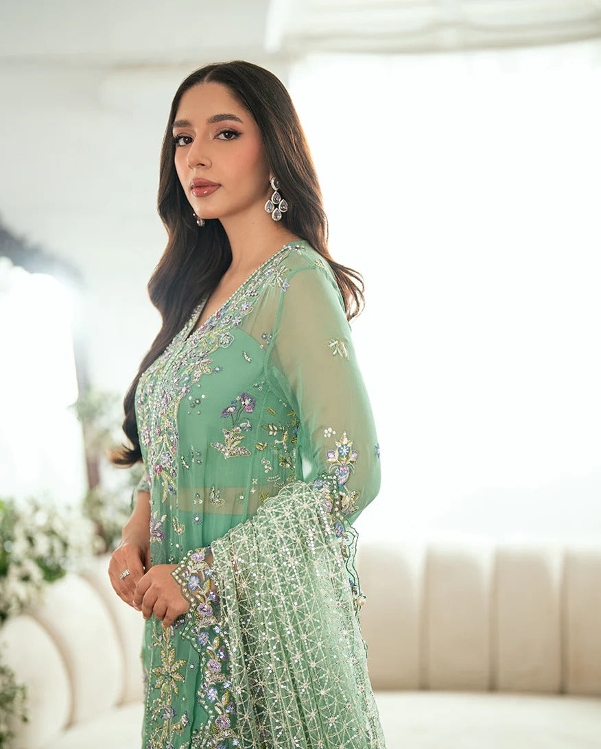 Shop this sea green chiffon suit with hand embellishments, sequinned net dupatta, raw silk trousers, and handcrafted tassels. Perfect for festive occasions!