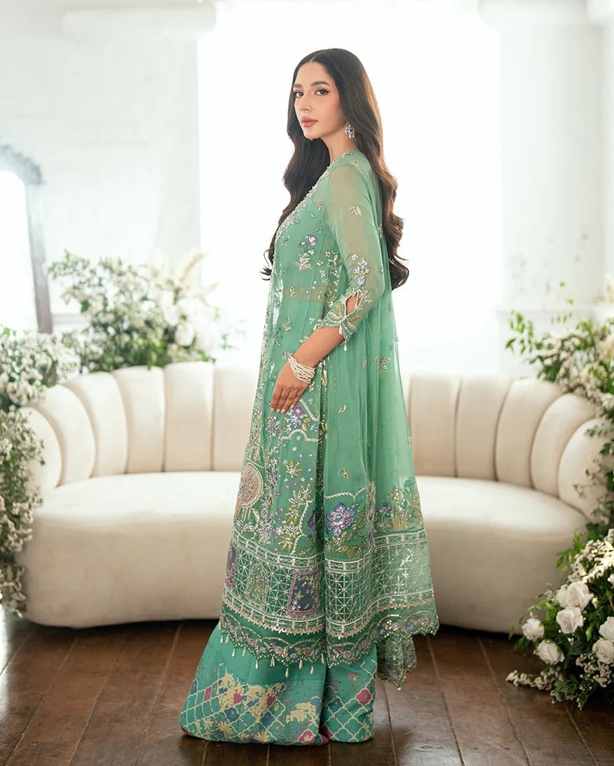 Shop this sea green chiffon suit with hand embellishments, sequinned net dupatta, raw silk trousers, and handcrafted tassels. Perfect for festive occasions!