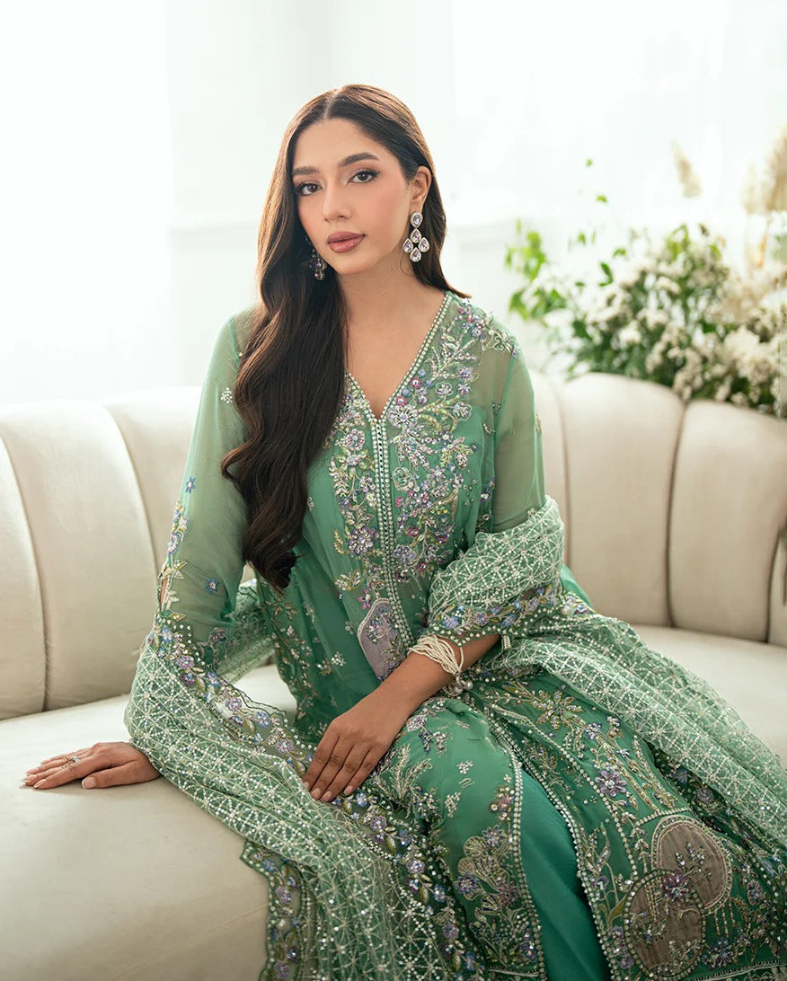 Shop this sea green chiffon suit with hand embellishments, sequinned net dupatta, raw silk trousers, and handcrafted tassels. Perfect for festive occasions!