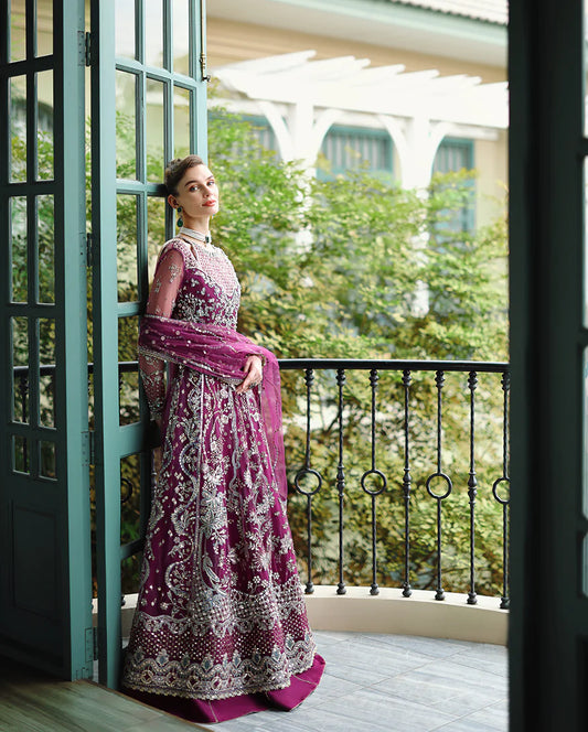 Hand-embellished embroidered net shirt with sequins and pearls, paired with a dyed raw silk lehenga and embroidered net dupatta—perfect for weddings and festive wear.