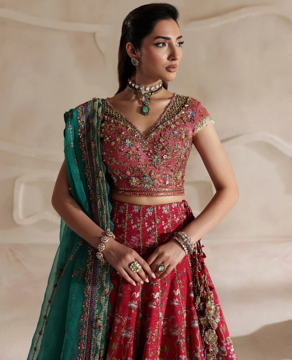 Radiant hot pink raw silk lehenga with a shikargah blouse, golden adda work, and teal embroidered dupatta — a bold, regal blend of color, craft, and heritage.