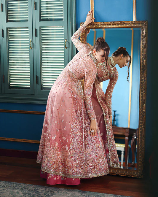 Hand-embroidered net shirt with sequins & organza, paired with printed silk trouser and net dupatta. Perfect for festive & wedding occasions.