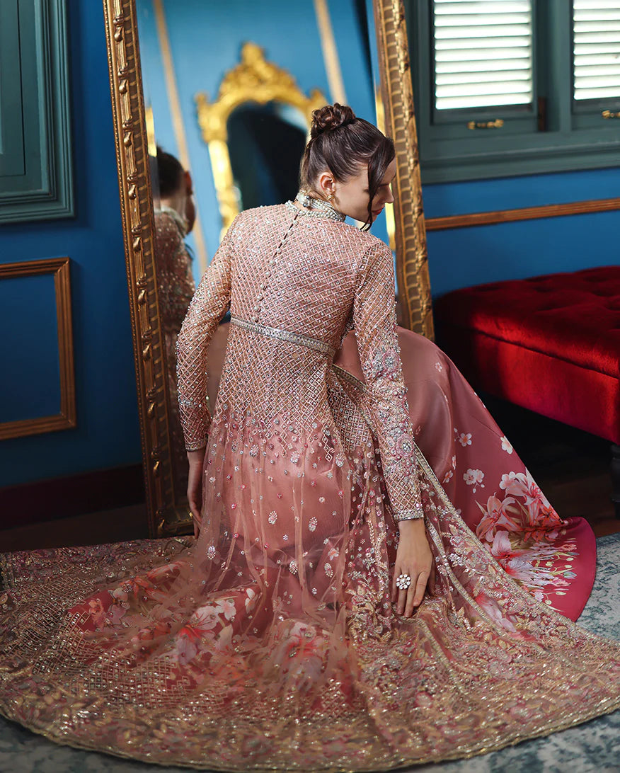 Hand-embroidered net shirt with sequins & organza, paired with printed silk trouser and net dupatta. Perfect for festive & wedding occasions.