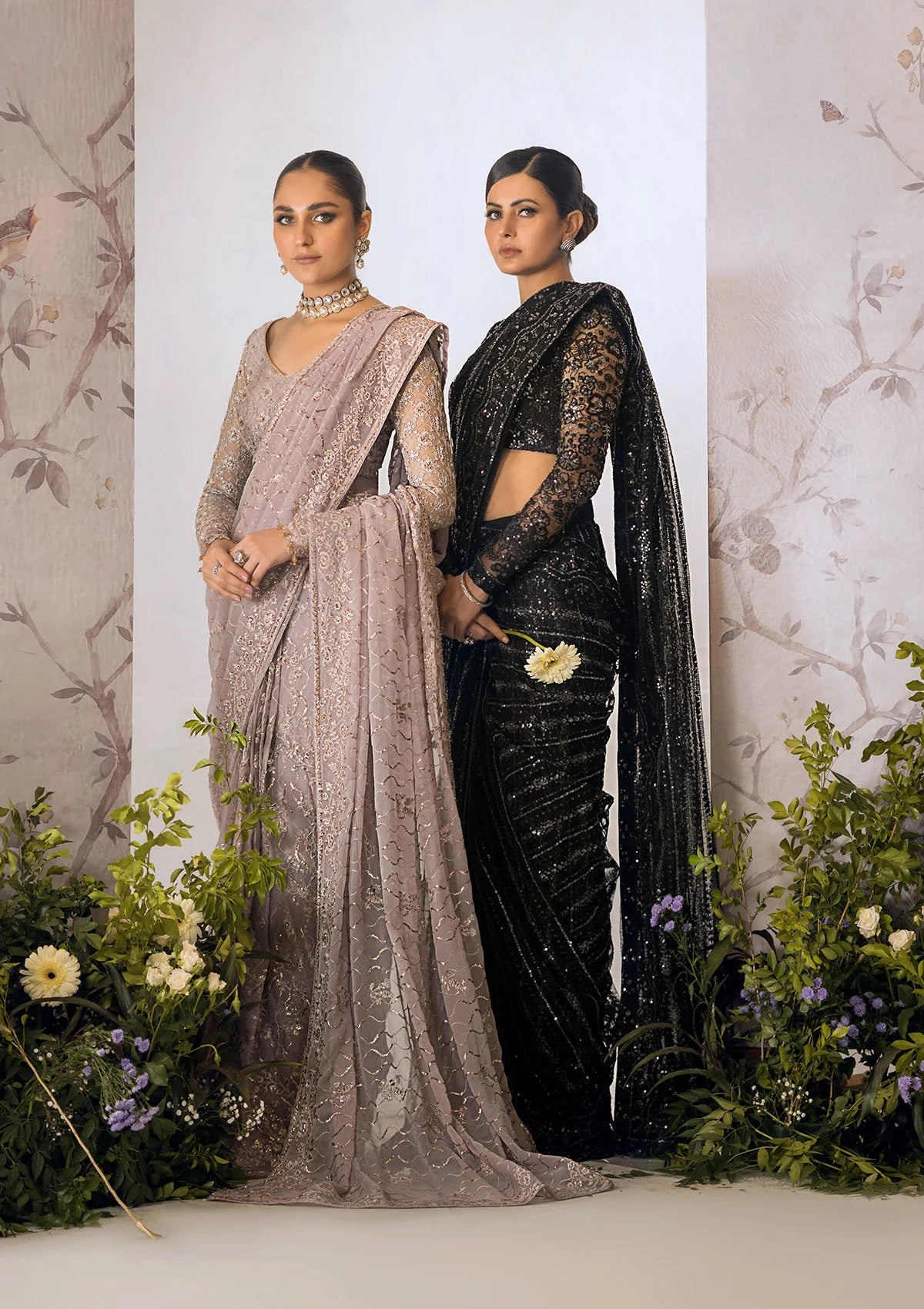 Ethereal lilac chiffon saree with self embroidered fall and pallu, paired with a net blouse adorned with silver tilla, rose gold sequins and organza borders.