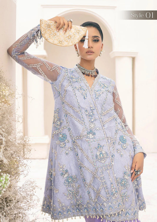 Exquisite lavender net ensemble featuring crystal and pearl embellishments, tilla-infused embroidery, masoori silk pants, and an organza jacquard dupatta. Styled as a short shirt with draped skirt or long shirt with sharara pants.