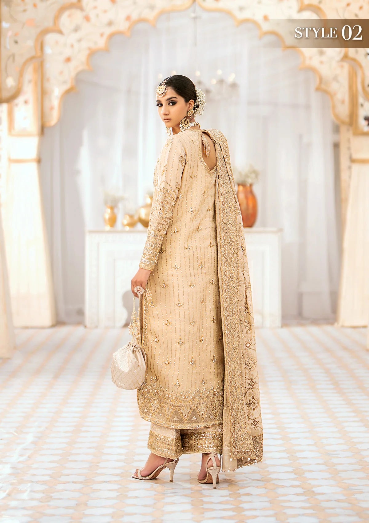 Opulent kundan zari ensemble with embellished neckline, daman patch, rich organza borders, jamawaar pants, and an embroidered zari dupatta. Styled as a long shirt with crushed sharara or izhaar pants.