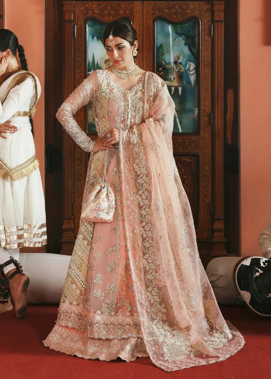 Stunning jewel-toned lehenga suit with hand-embellished shirt, embroidered borders, and organza dupatta for a regal festive look.