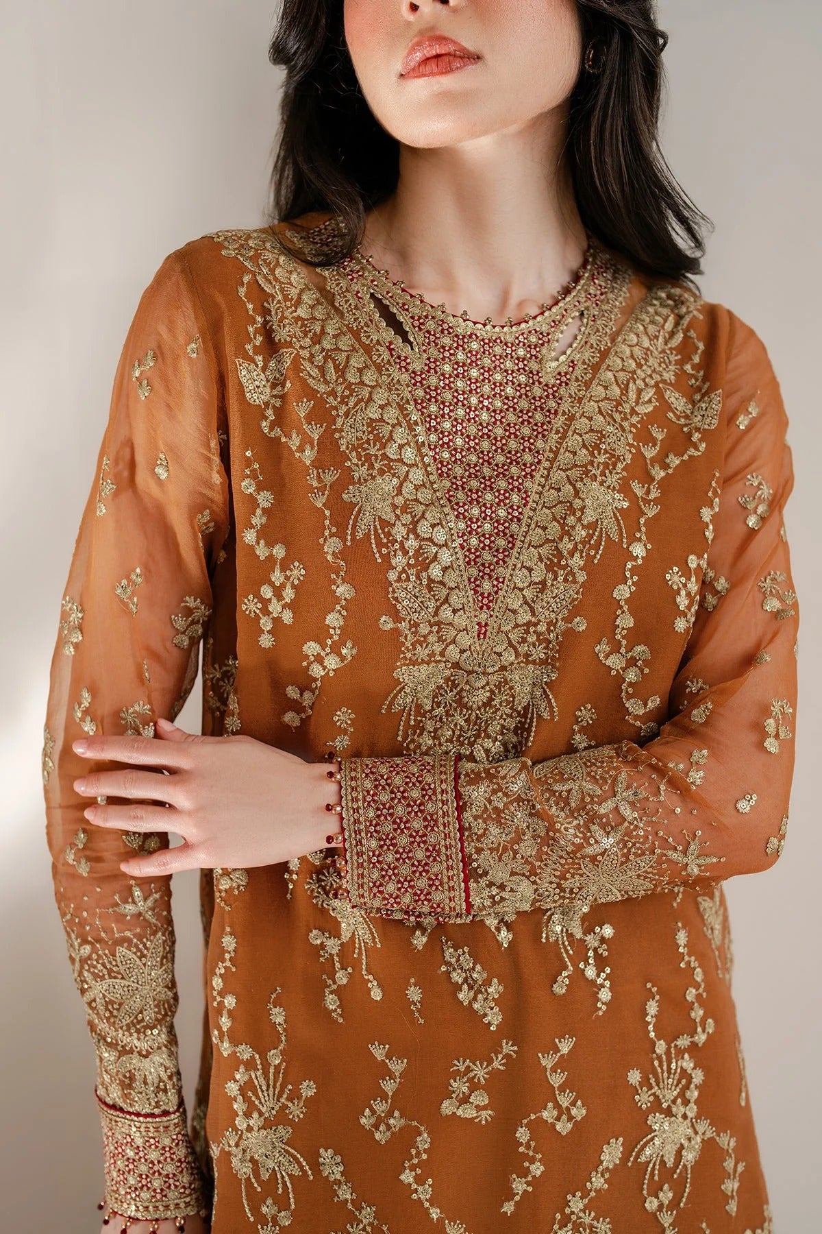 Chiffon and rawsilk elegance with intricate embroidery and organza dupatta. Ideal for formal wear and events. Make a bold style statement in UC-3077.
