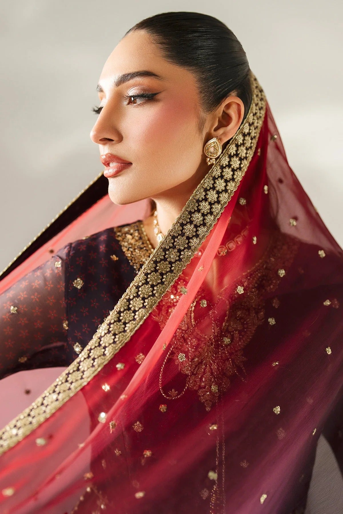 Intricately embroidered chiffon suit with digital prints, bordered dupatta, and raw silk bottom—crafted for timeless elegance and formal sophistication.