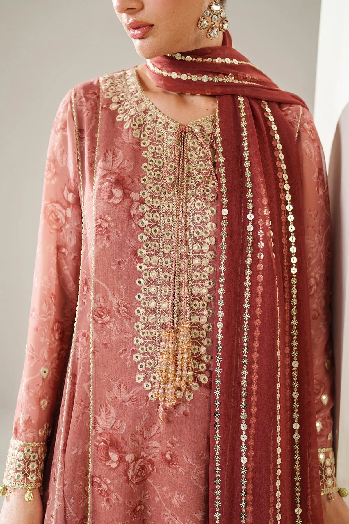 Digitally printed chiffon suit with embroidered borders & dupatta. Features rawsilk bottom for a rich, elegant look. Perfect for formal & festive wear.