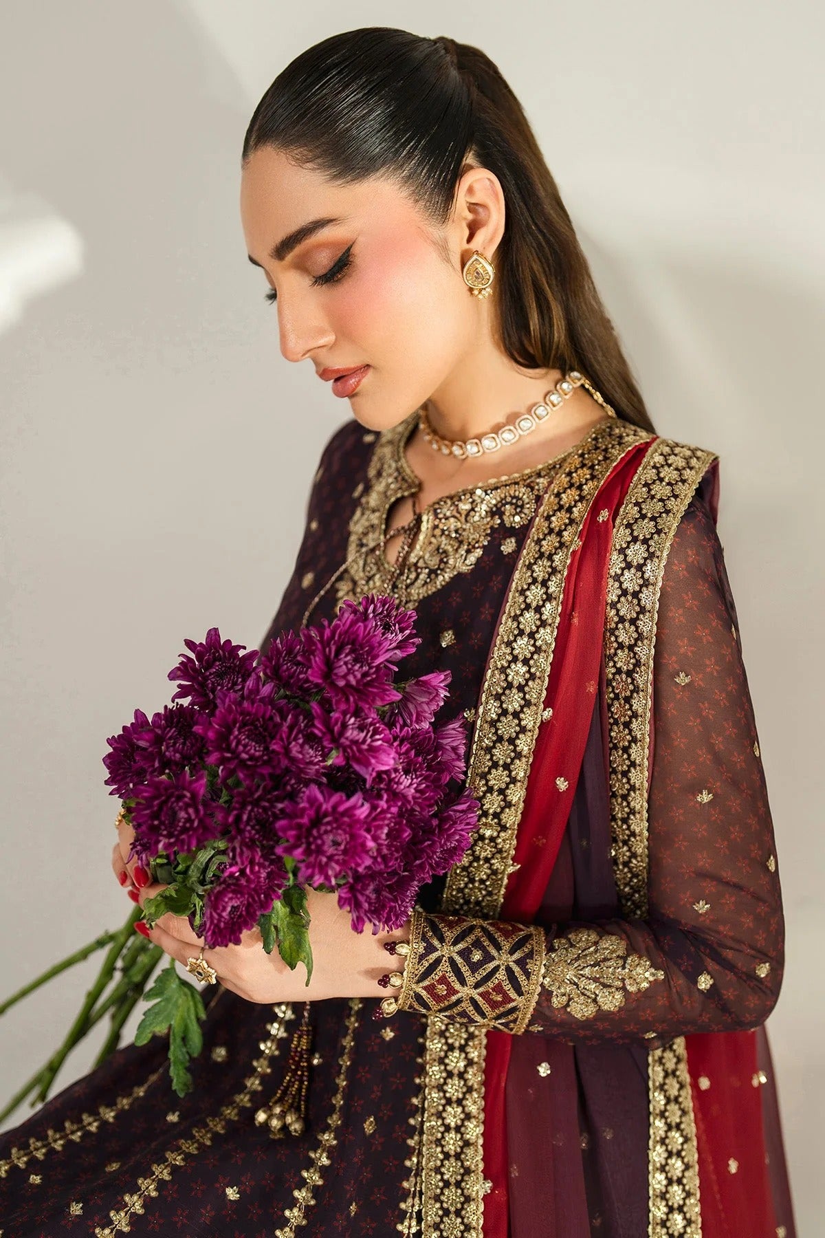 Intricately embroidered chiffon suit with digital prints, bordered dupatta, and raw silk bottom—crafted for timeless elegance and formal sophistication.