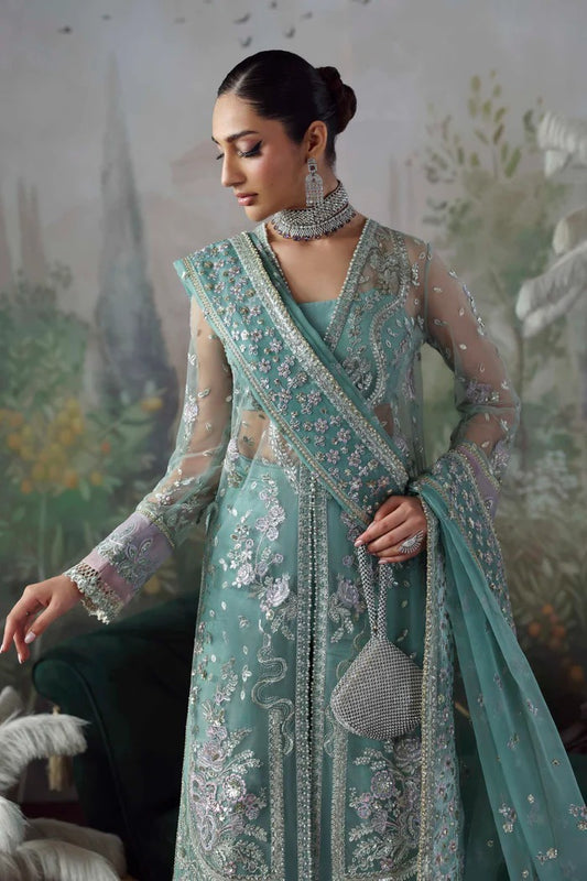 Chic net & organza suit with embroidered panels, sleeves, dupatta & borders, paired with silk inner and trouser—crafted for elegance & timeless style.