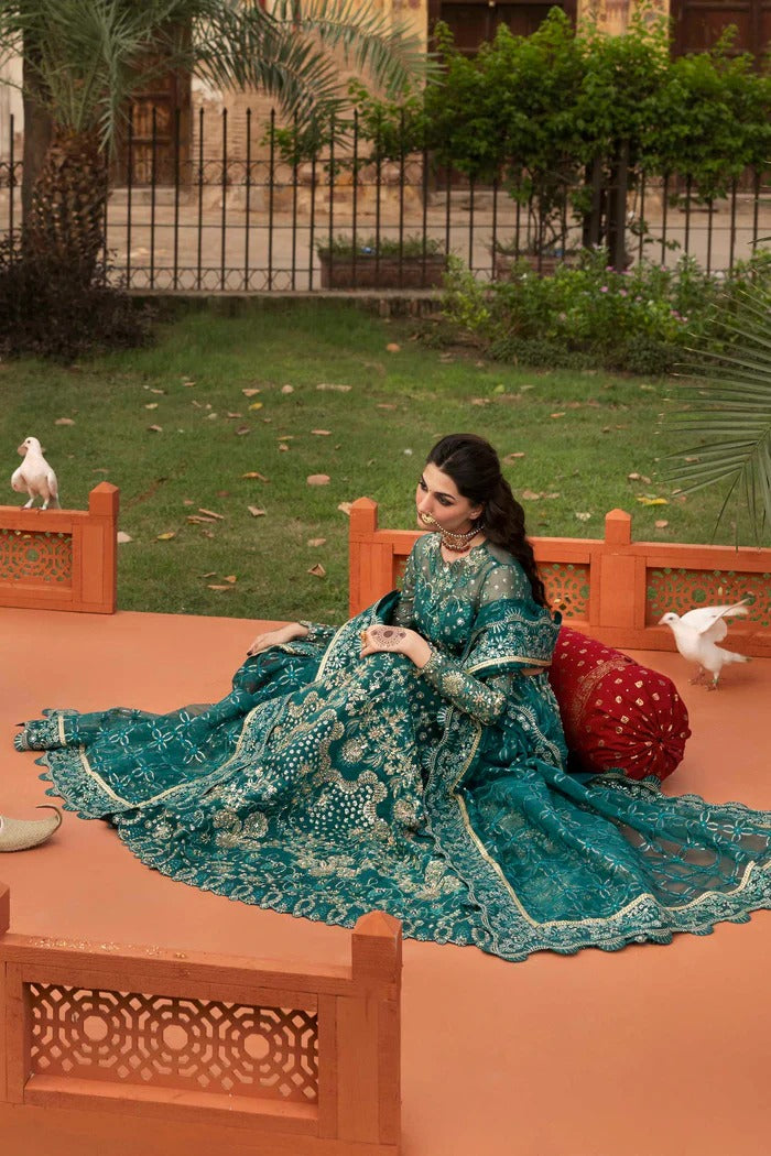 Elegant organza suit with embellished panels, blouse, sleeves & dupatta, paired with inner—crafted for timeless beauty, sophistication & luxury.
