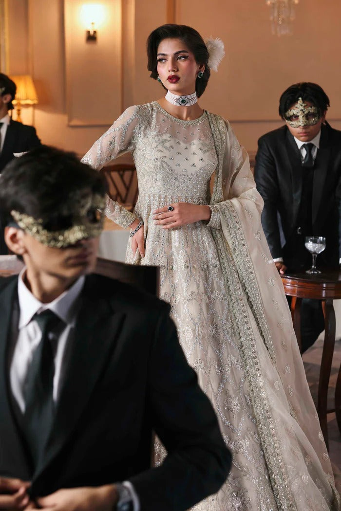 Chic organza dress featuring embroidered panels, blouse, sleeves & dupatta, paired with raw silk inner—crafted for timeless elegance and style.