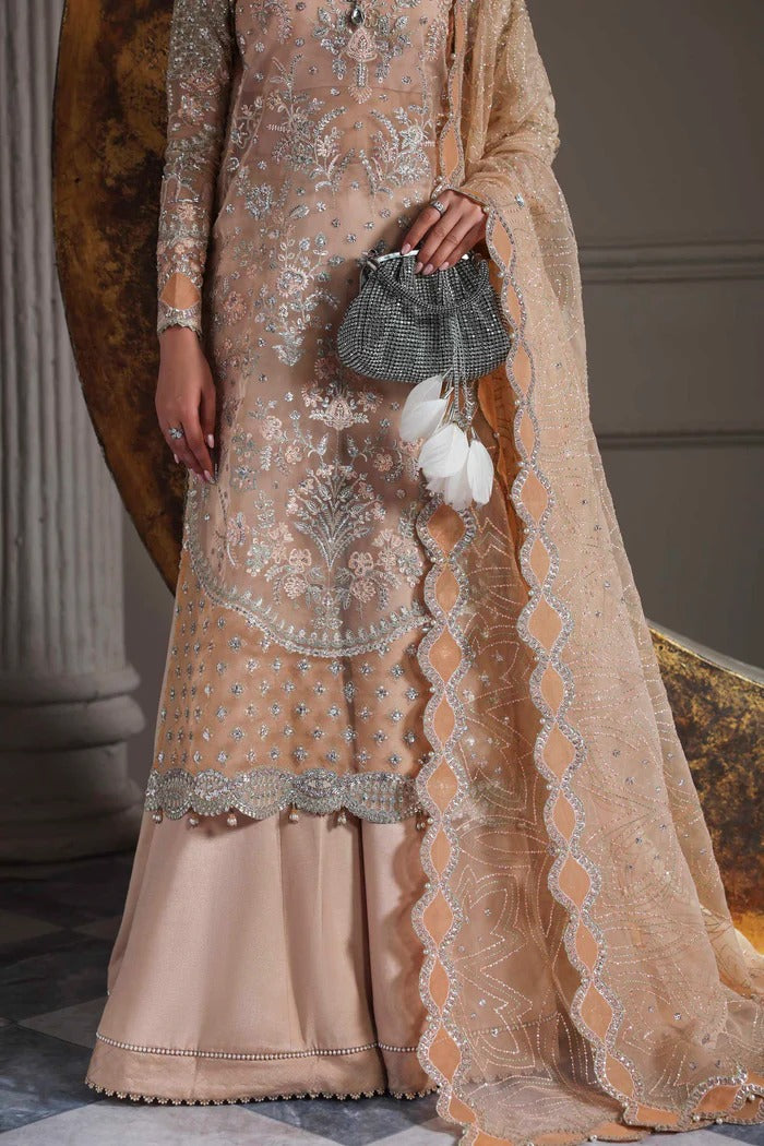 Elegant organza suit featuring embroidered front, back, sleeves, dupatta & trouser with borders, paired with silk inner—crafted for timeless grace.