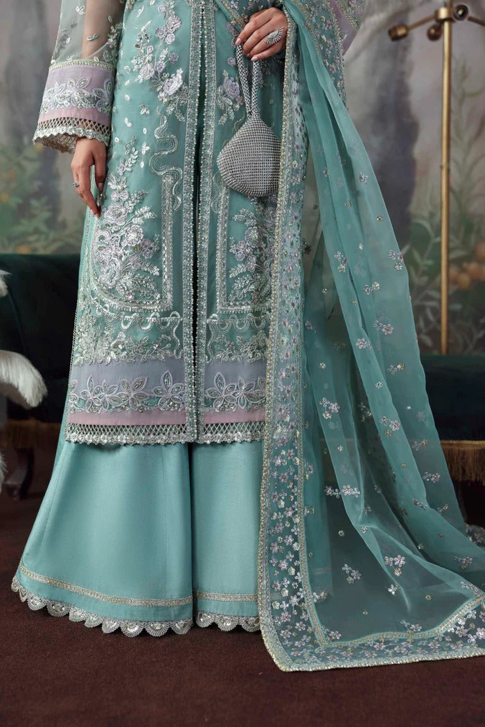 Chic net & organza suit with embroidered panels, sleeves, dupatta & borders, paired with silk inner and trouser—crafted for elegance & timeless style.