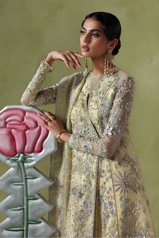 Graceful butter yellow silk suit with embroidered organza panels, embellished dupatta, and printed silk trousers. A stunning choice for festive and formal occasions.