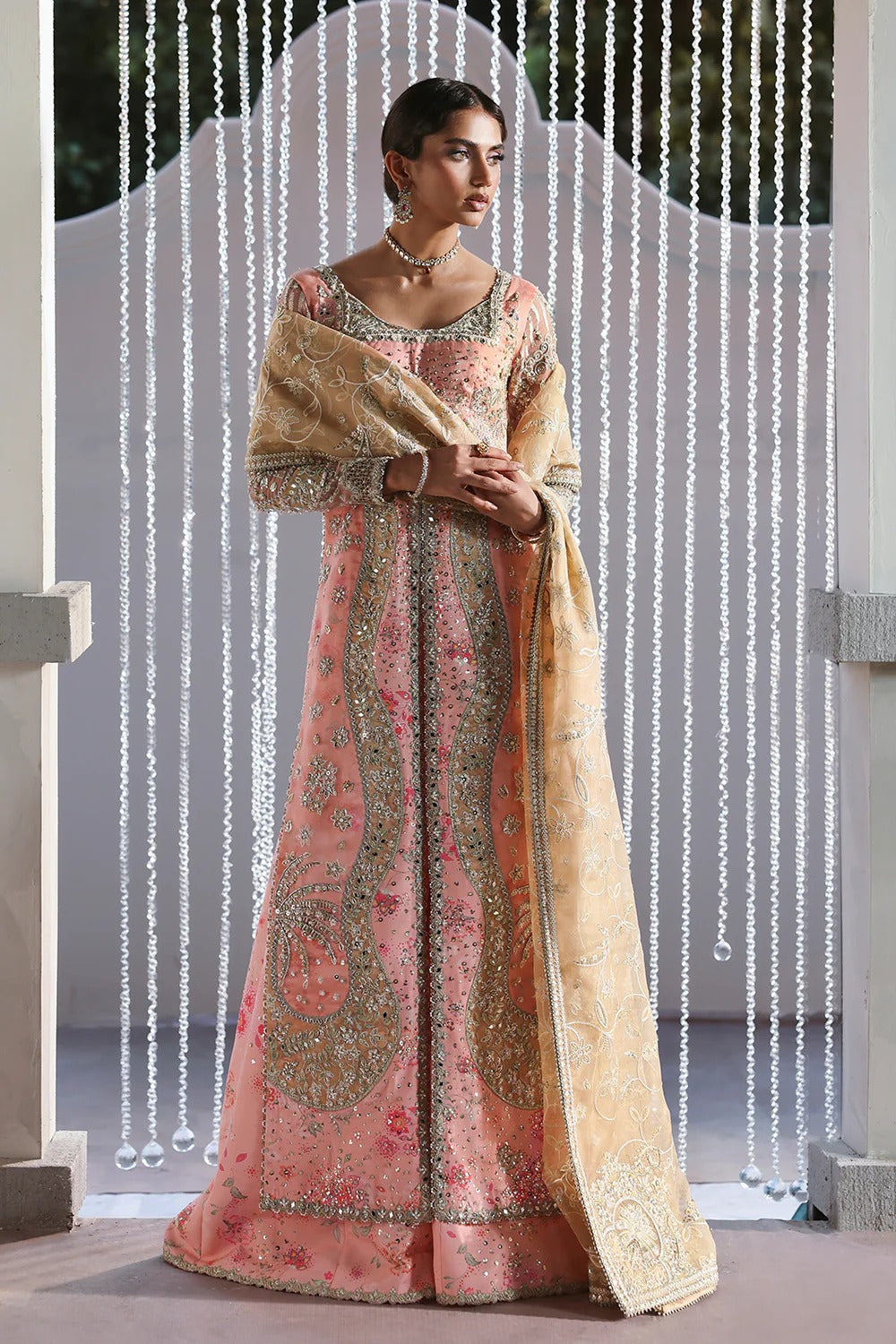 Beautiful printed pink silk suit with embroidered organza panels, embellished dupatta, and stylish sharara. Perfect for weddings, festive, and formal occasions.