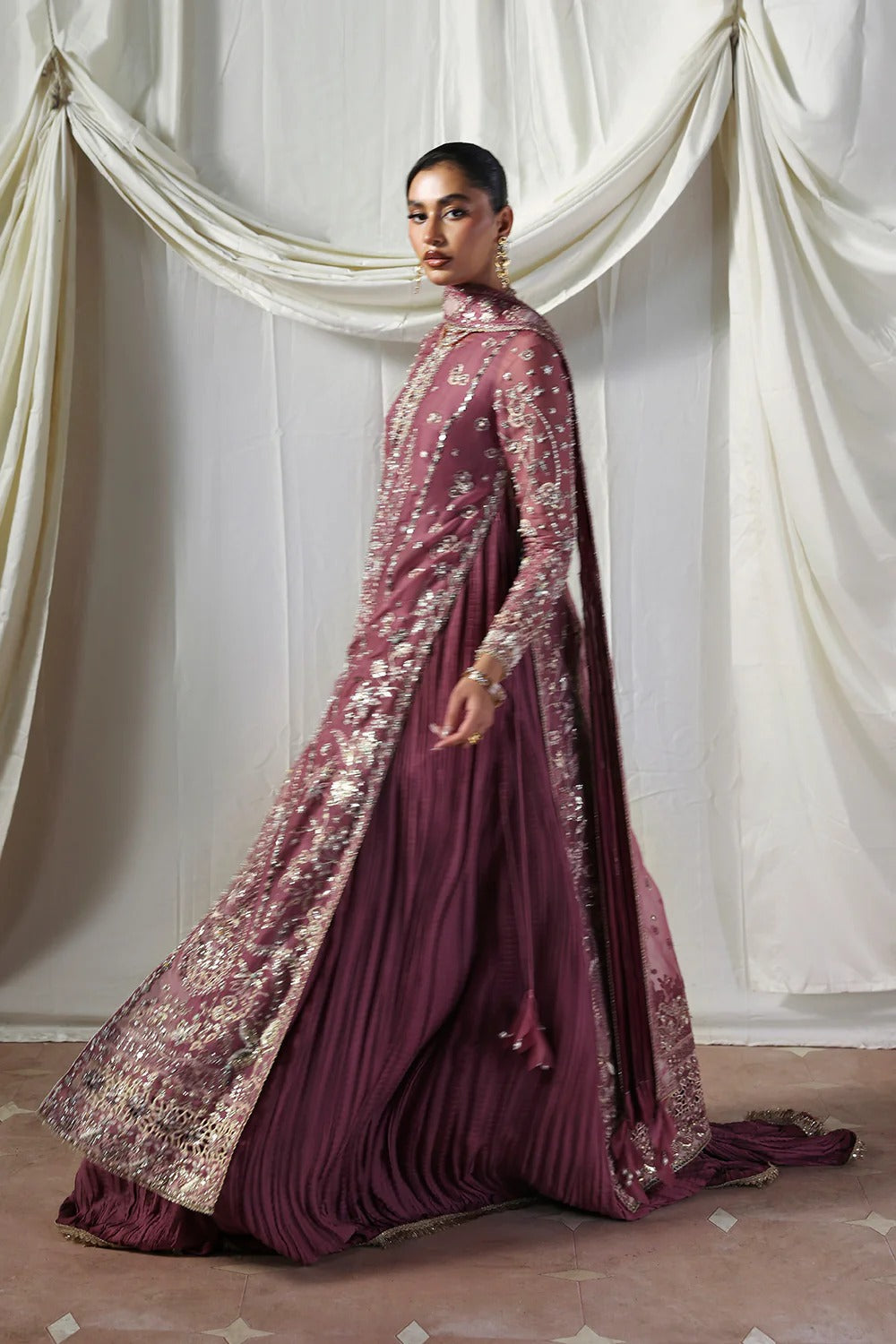 Stylish mauve silk gown featuring embroidered organza panels, embellished dupatta, and crushed inner gown. A graceful ensemble perfect for weddings & festive wear.
