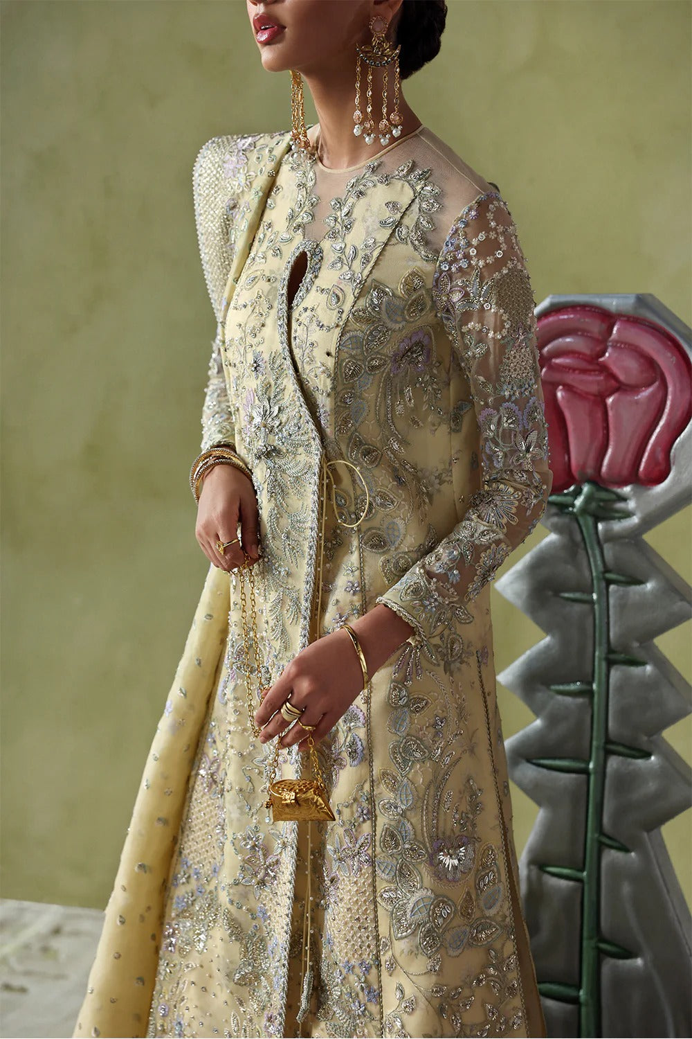 Graceful butter yellow silk suit with embroidered organza panels, embellished dupatta, and printed silk trousers. A stunning choice for festive and formal occasions.