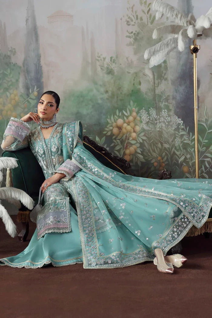 Chic net & organza suit with embroidered panels, sleeves, dupatta & borders, paired with silk inner and trouser—crafted for elegance & timeless style.