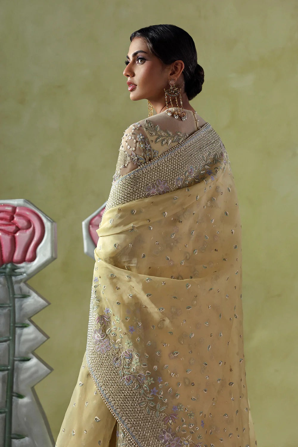 Graceful butter yellow silk suit with embroidered organza panels, embellished dupatta, and printed silk trousers. A stunning choice for festive and formal occasions.
