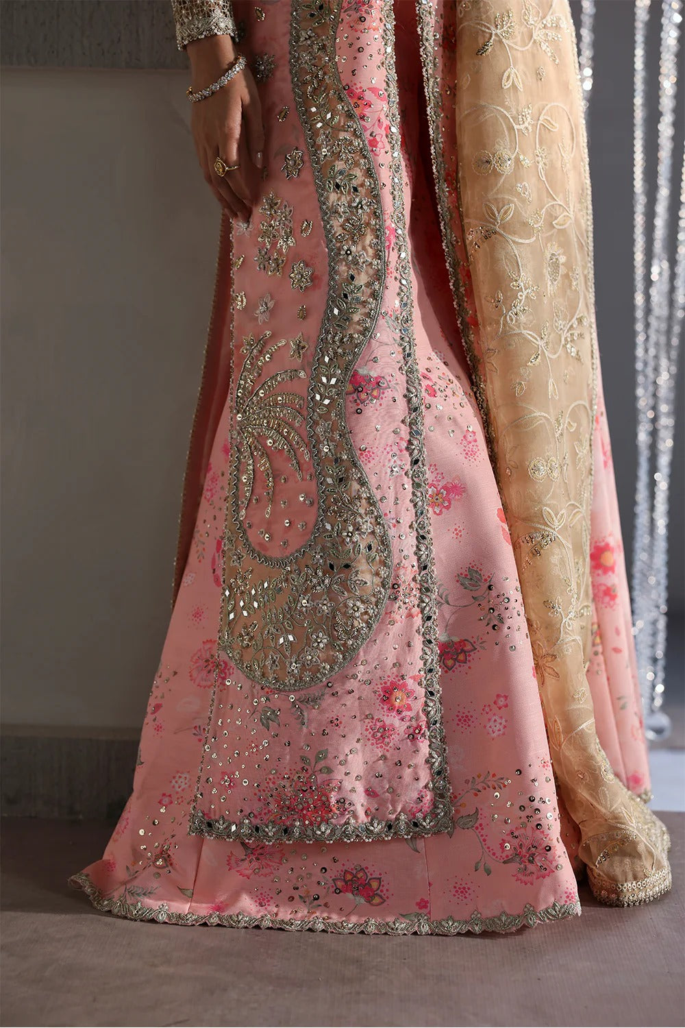 Beautiful printed pink silk suit with embroidered organza panels, embellished dupatta, and stylish sharara. Perfect for weddings, festive, and formal occasions.