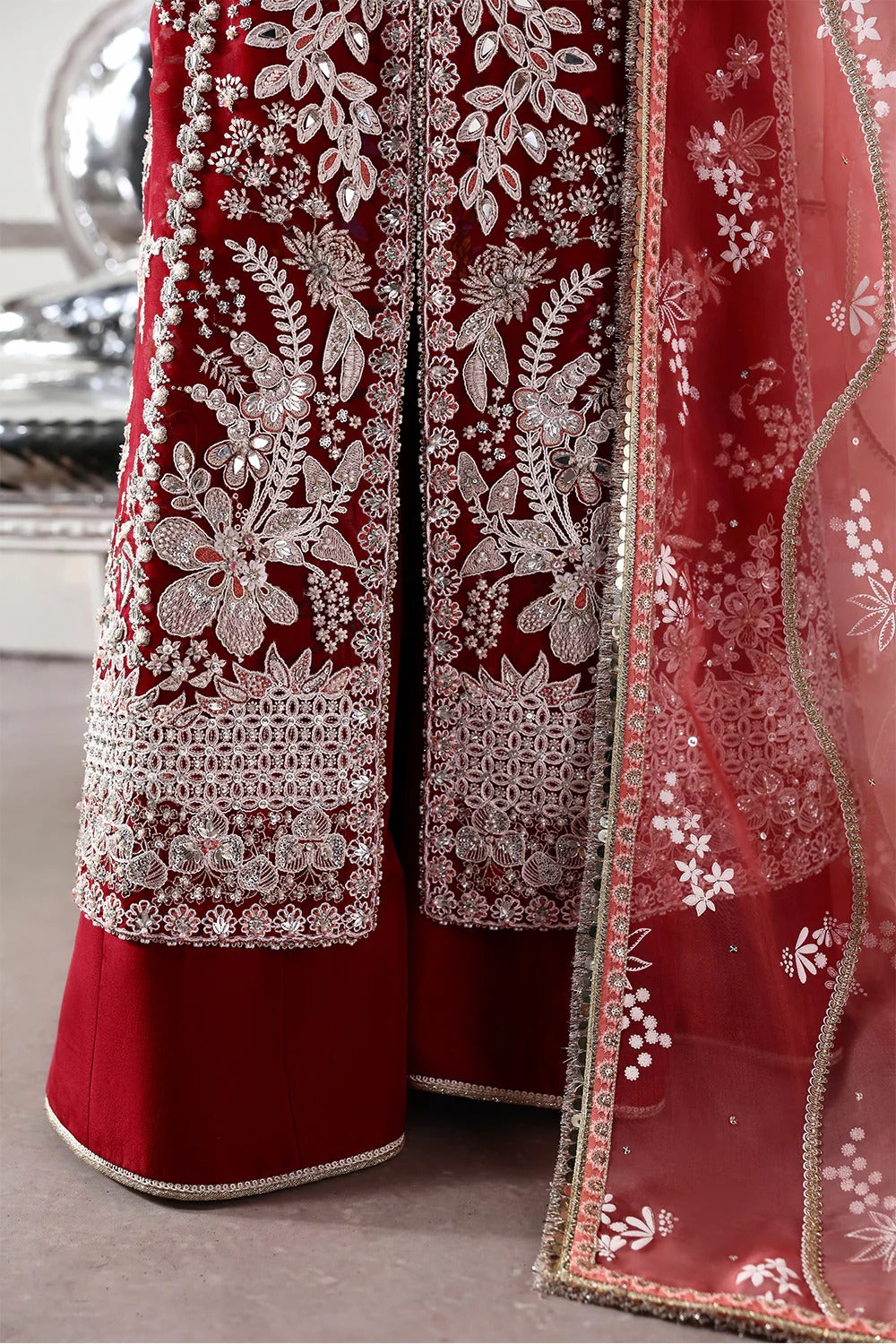 Stunning Crimson Red suit featuring embroidered organza panels, hand embellishments, silk trouser, and printed organza dupatta with elegant details.