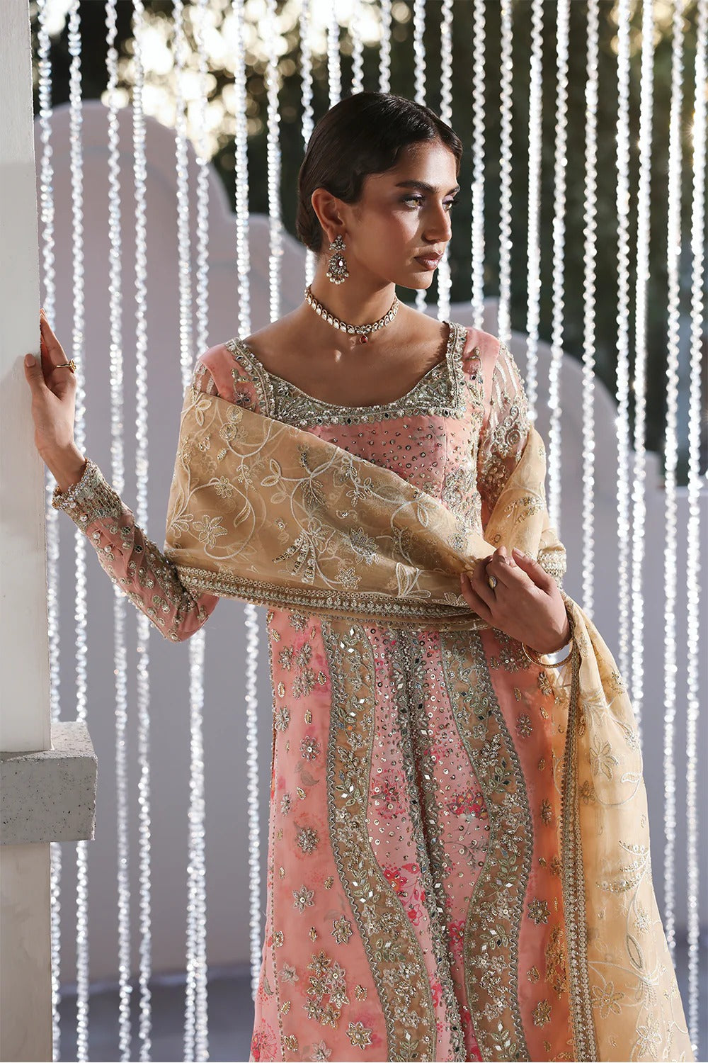 Beautiful printed pink silk suit with embroidered organza panels, embellished dupatta, and stylish sharara. Perfect for weddings, festive, and formal occasions.