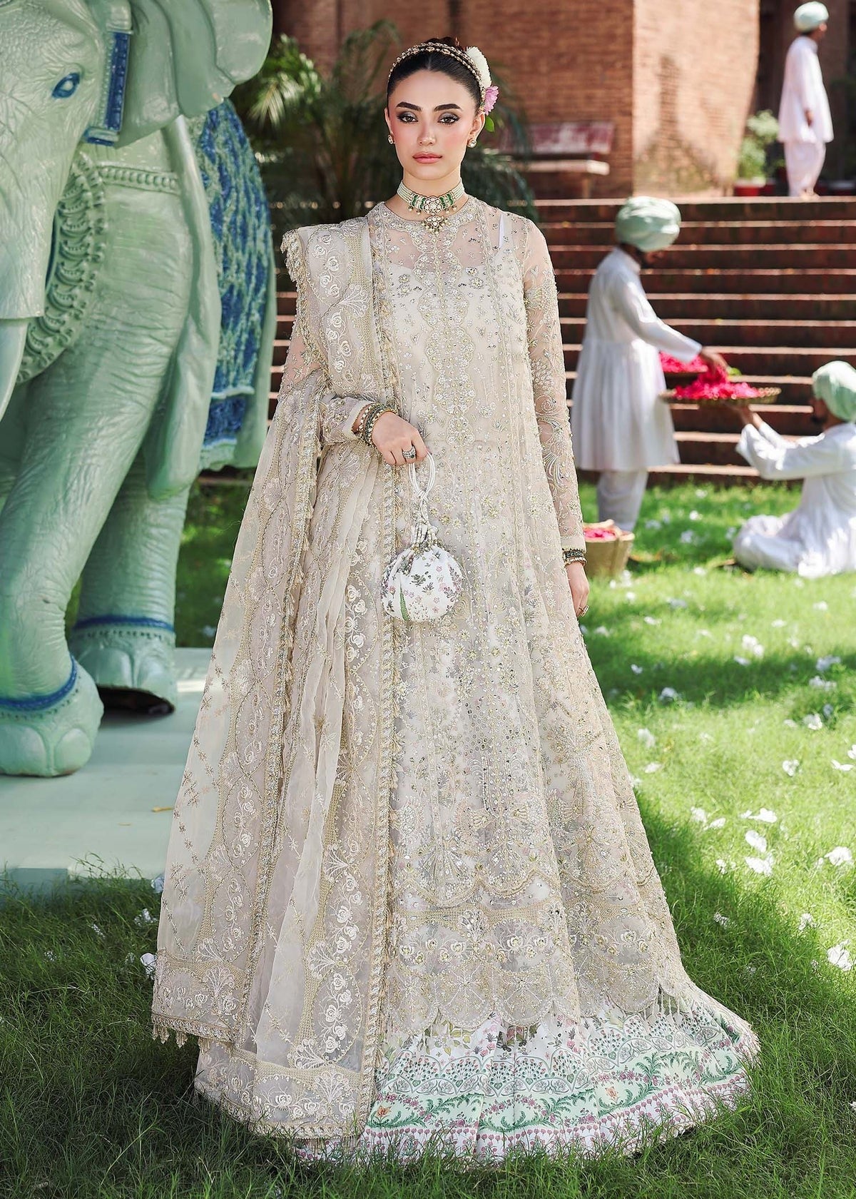 Elevate your look with this dusty white organza outfit featuring intricate hand embroidery, printed raw silk trouser, and elegant embroidered dupatta.